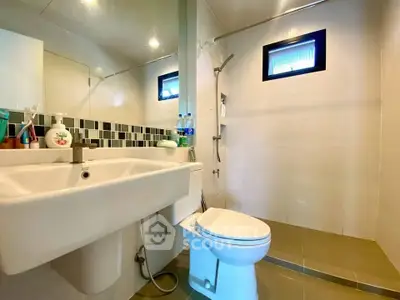 Modern bathroom with sleek fixtures and stylish tile accents.