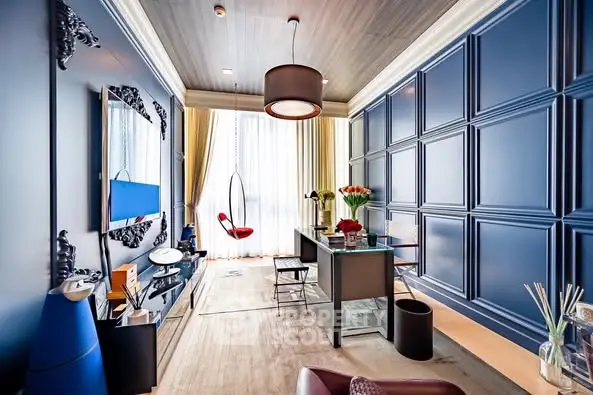 Luxurious modern living room with elegant blue panel walls and chic hanging chair.