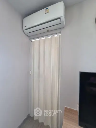 Modern interior with air conditioning and sliding door, perfect for compact living spaces.