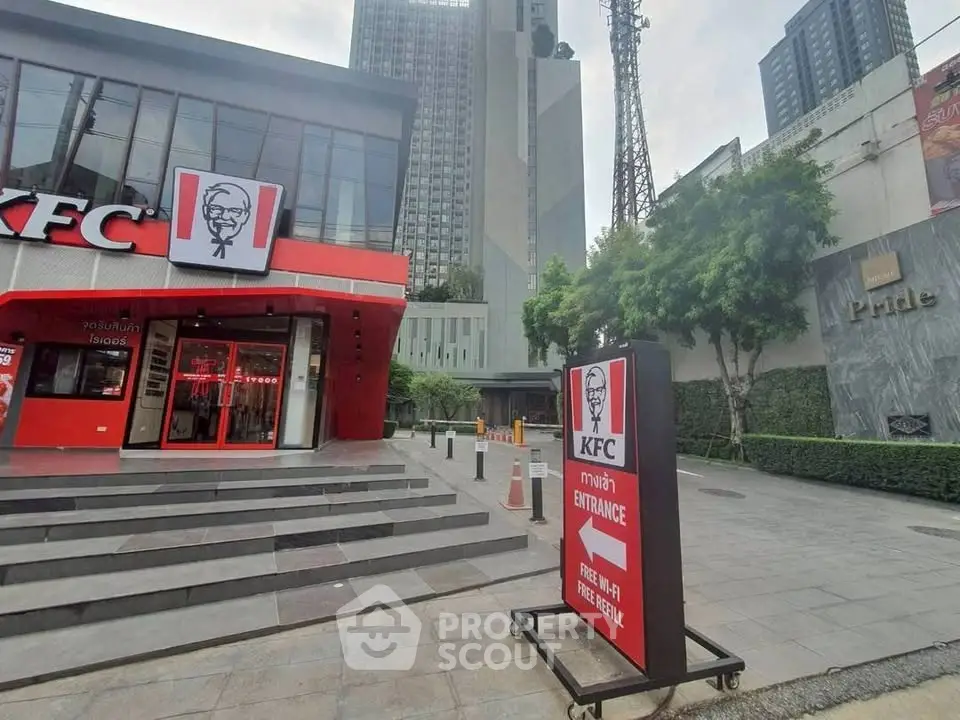 Modern commercial building exterior with KFC signage in urban setting.
