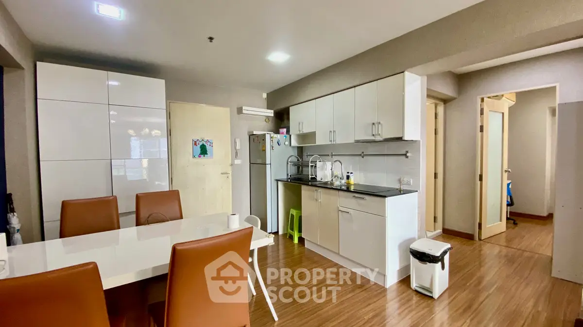 Modern open-layout kitchen with dining area and sleek cabinetry.