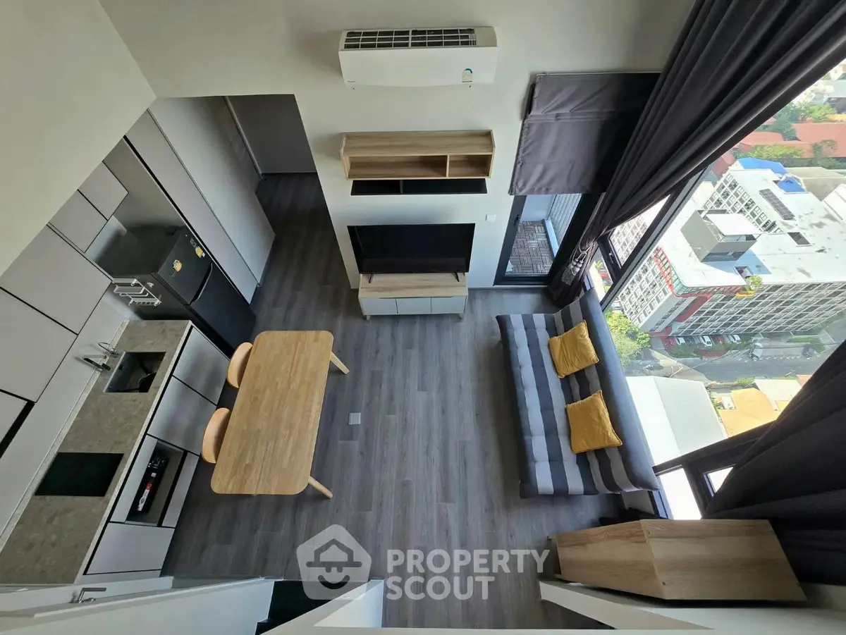 Modern loft apartment with open layout, featuring stylish kitchen and living area with city view.