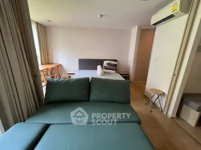 Modern studio apartment with cozy bed and stylish sofa in open layout