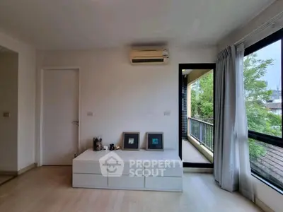 Bright living room with balcony access and modern decor
