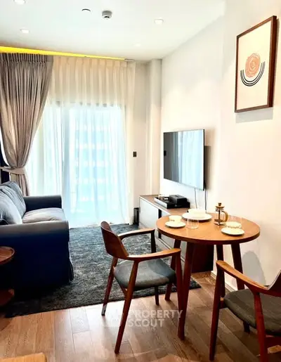 Modern living room with stylish furniture and natural light, perfect for relaxation and entertainment.