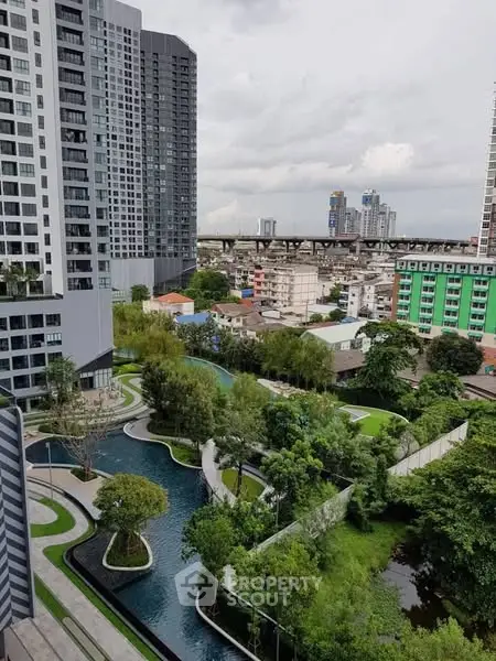Stunning urban view with modern high-rise buildings and lush green landscape.