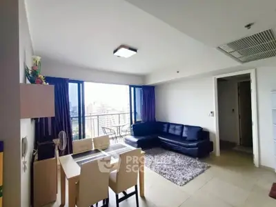 Modern living room with city view, stylish furniture, and dining area in open layout apartment.