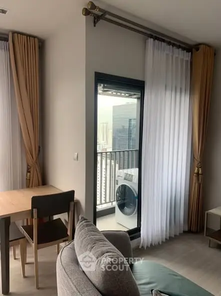 Modern living room with balcony view and washing machine