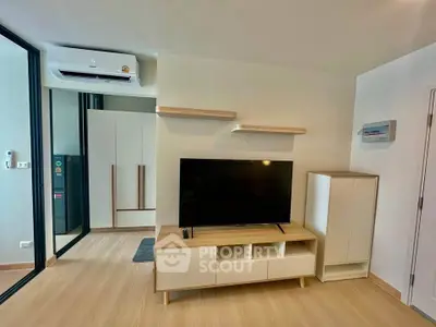Modern living room with sleek TV unit and air conditioning in a stylish apartment.