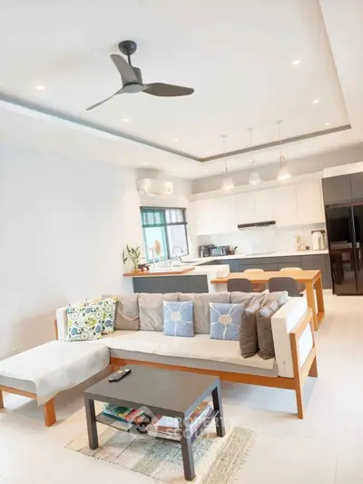 Modern open-plan living room with stylish kitchen and cozy seating area, perfect for entertaining.
