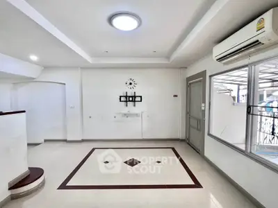 Spacious modern living room with air conditioning and stylish ceiling design