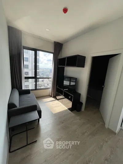 Modern living room with city view, sleek furniture, and natural light.