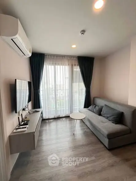 Modern living room with sleek furniture and natural light, perfect for urban living.