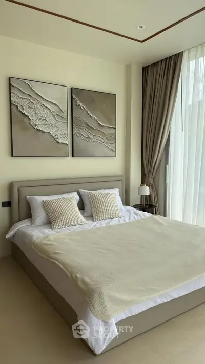 Elegant bedroom with modern decor and large window offering natural light