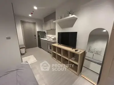 Modern compact studio apartment with sleek design and smart storage solutions.