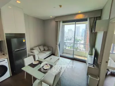 Modern open-plan living room with city view and balcony access in a high-rise apartment.