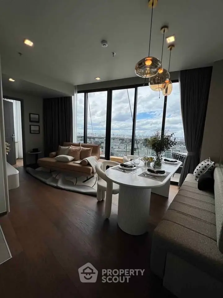 Luxurious living room with panoramic city view, elegant decor, and modern lighting fixtures.