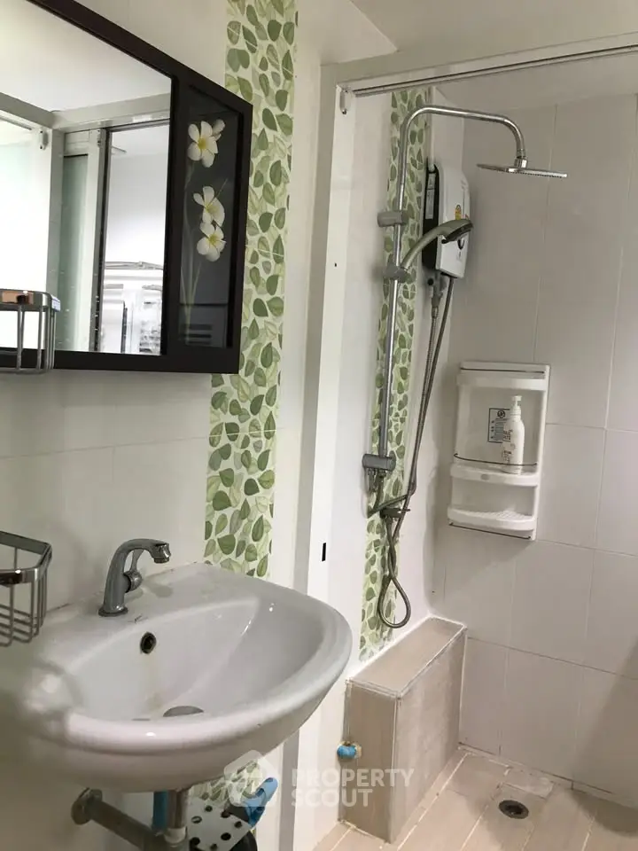 Modern bathroom with stylish shower and floral tile accents