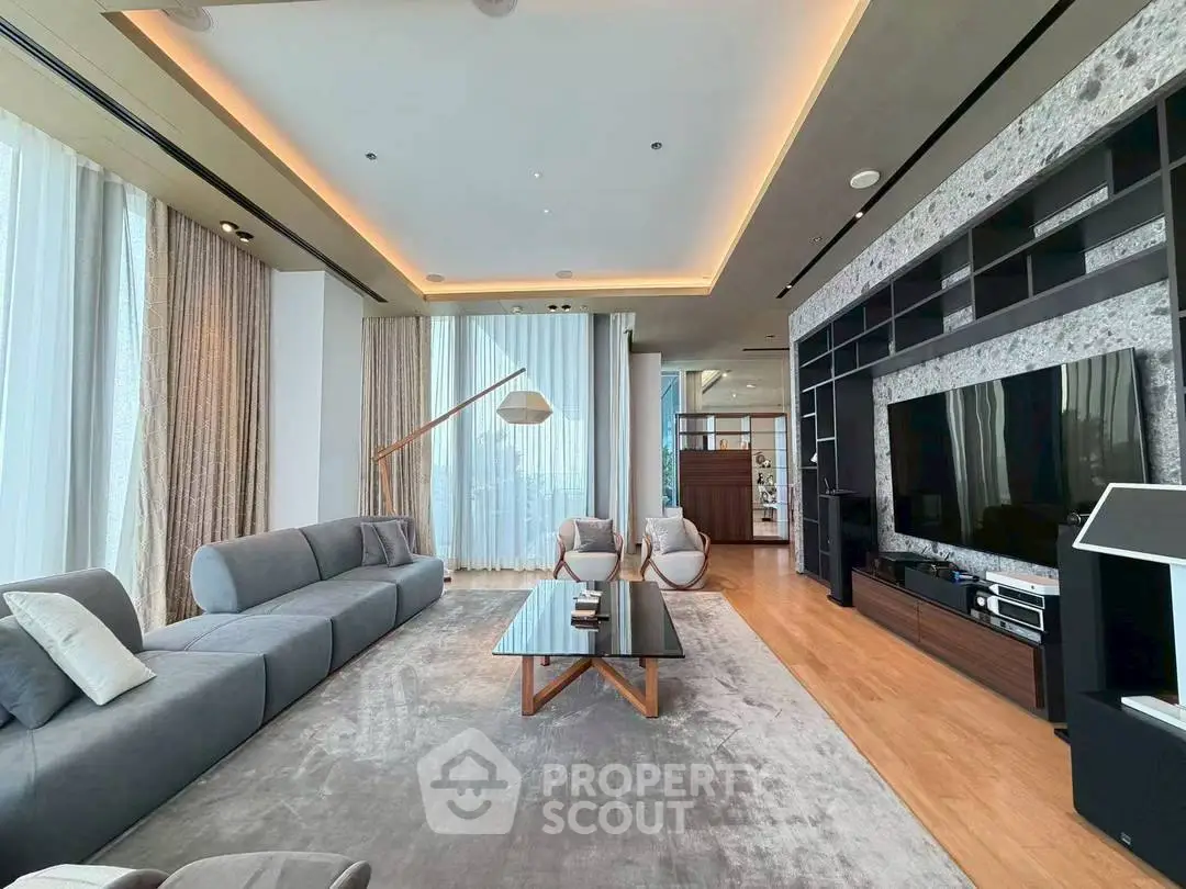 Luxurious modern living room with sleek design and large windows, featuring a spacious seating area and entertainment center.