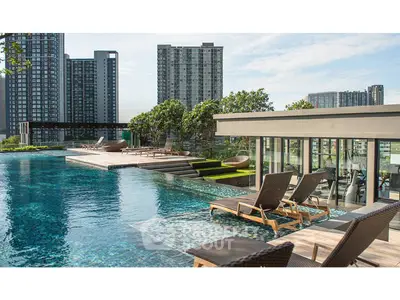 Luxurious rooftop pool with stunning cityscape views and modern lounge chairs.