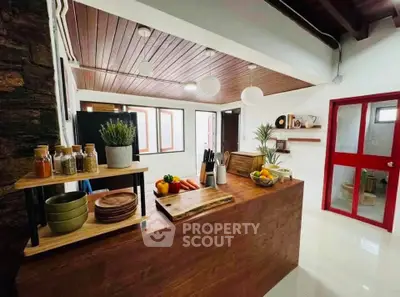 Charming kitchen with wooden accents and modern decor, featuring open layout and natural light.