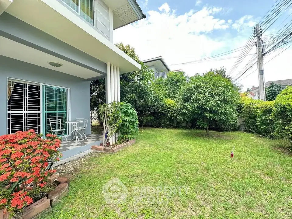 Charming suburban home with lush garden and cozy patio, perfect for outdoor relaxation.