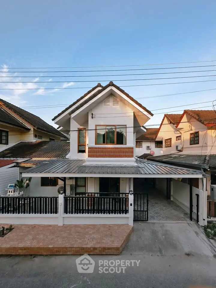 Charming two-story house with modern design and spacious driveway in a serene neighborhood.