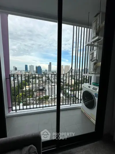 Stunning high-rise balcony with cityscape view and laundry area, perfect for urban living.