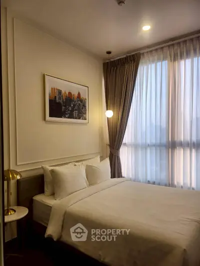 Cozy bedroom with city view, elegant decor, and soft lighting.