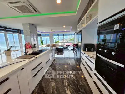 Luxurious modern kitchen with marble flooring and stunning ocean view