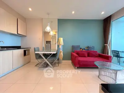 Modern living room with vibrant red sofa and sleek dining area