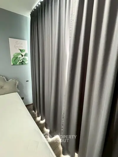 Cozy bedroom with elegant gray curtains and stylish decor