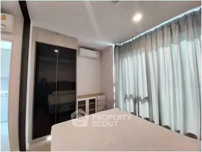 Modern bedroom with sleek wardrobe and air conditioning in stylish apartment