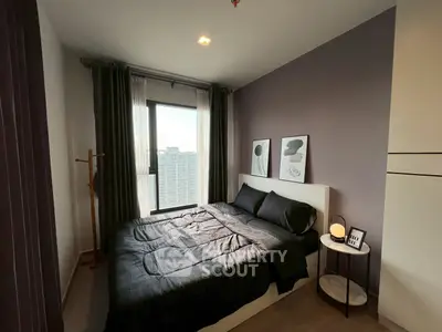 Modern bedroom with stylish decor and city view, featuring cozy bedding and elegant artwork.