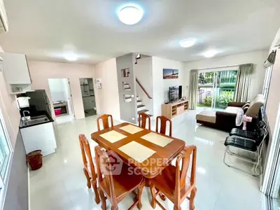 Spacious open-plan living and dining area with modern furnishings and garden view.