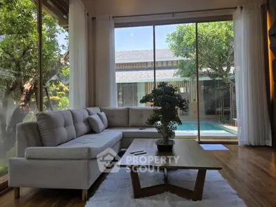 Spacious living room with pool view and modern decor