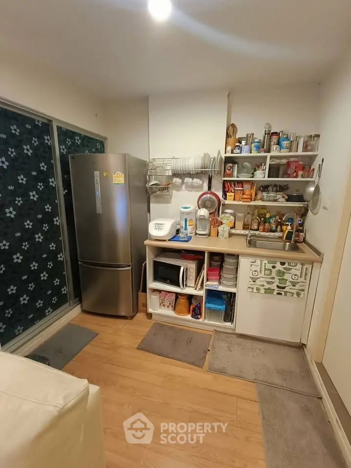 Cozy kitchen with modern appliances and open shelving in a compact layout.