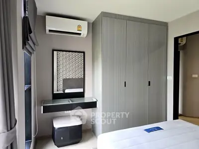 Modern bedroom with sleek wardrobe and air conditioning unit