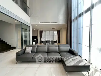 Luxurious modern living room with large windows and elegant furniture