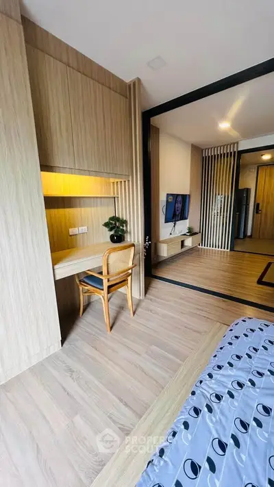 Modern apartment interior with open layout, featuring a cozy study area and stylish living room.