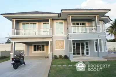 Modern two-story house with spacious driveway and lush green lawn