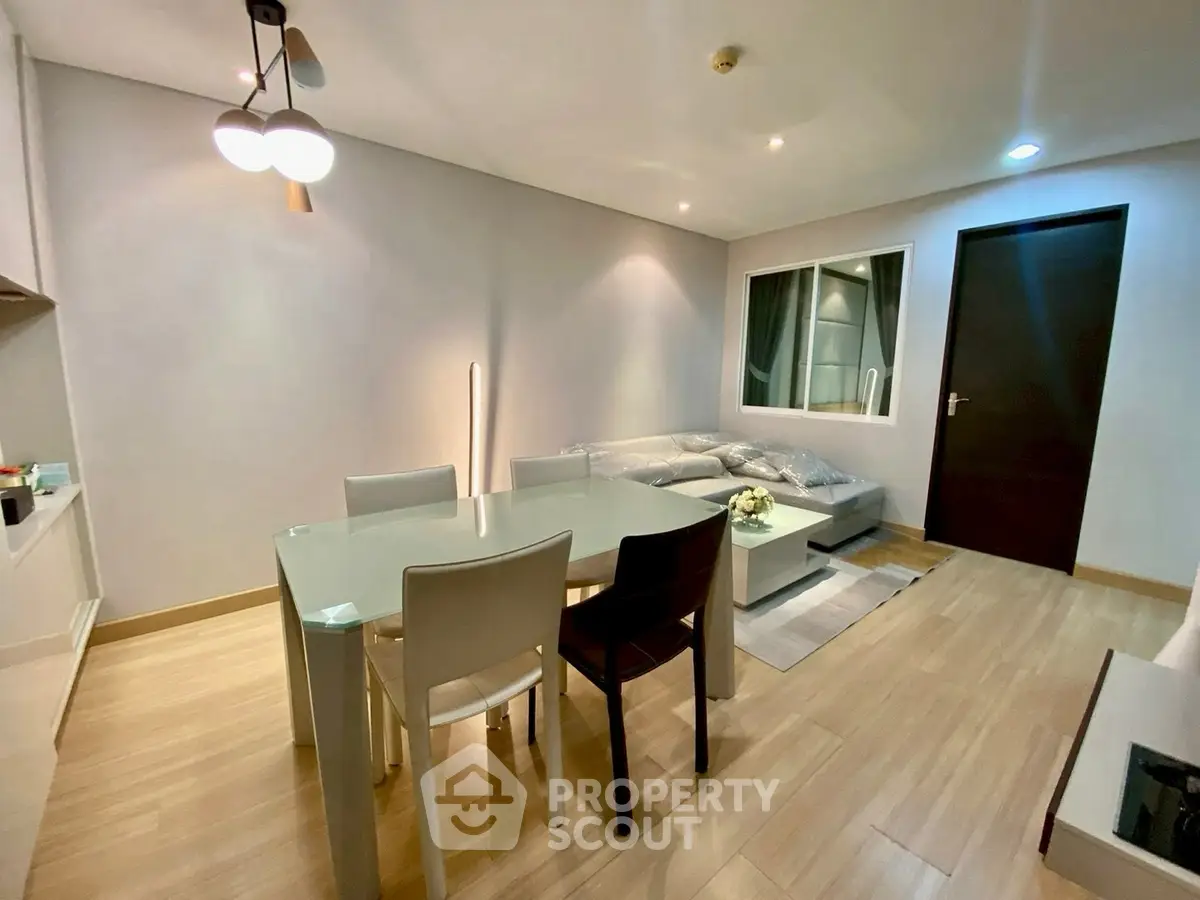 Modern living room with stylish dining area and cozy seating.