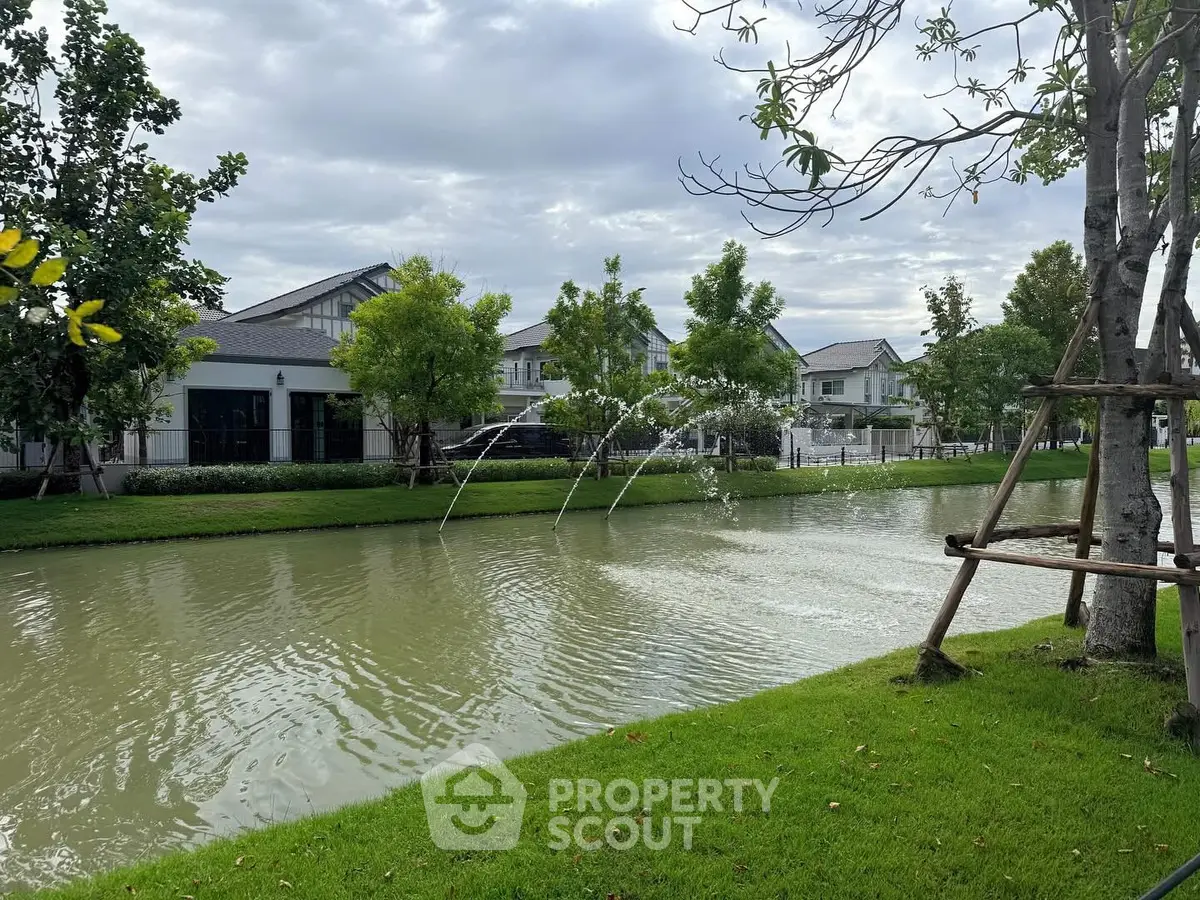 Charming residential area with serene water feature and lush greenery