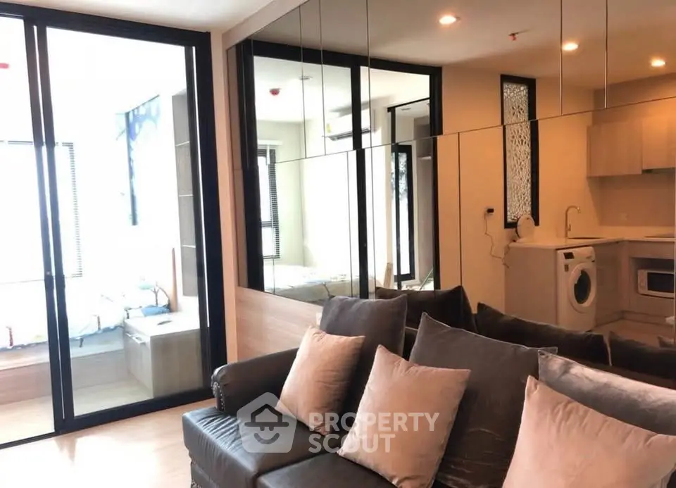 Modern living room with mirrored wall and cozy sofa in stylish apartment