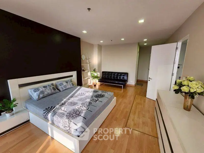Spacious modern bedroom with elegant decor and natural light