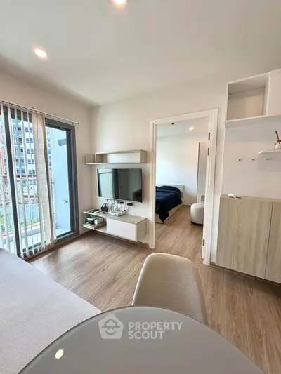 Modern living room with open layout and balcony view in stylish apartment