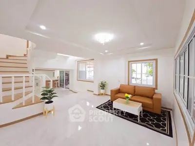 Spacious modern living room with elegant staircase and cozy seating area.