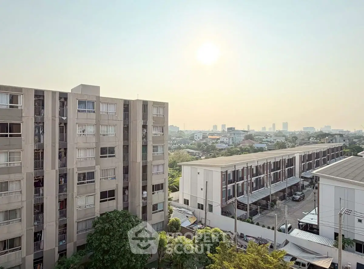 Stunning urban apartment complex with panoramic city views and lush greenery.