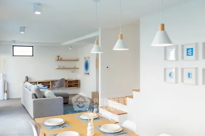Modern open-plan living and dining area with stylish decor and ample natural light.