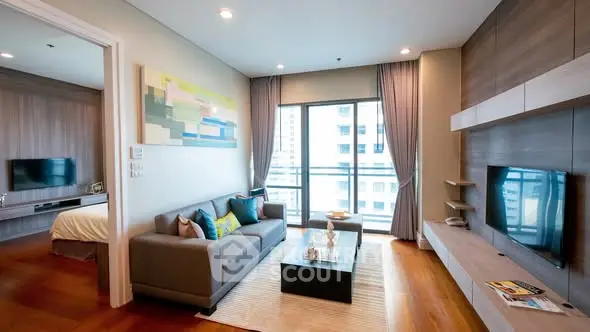 Modern living room with stylish decor and large windows in a high-rise apartment.